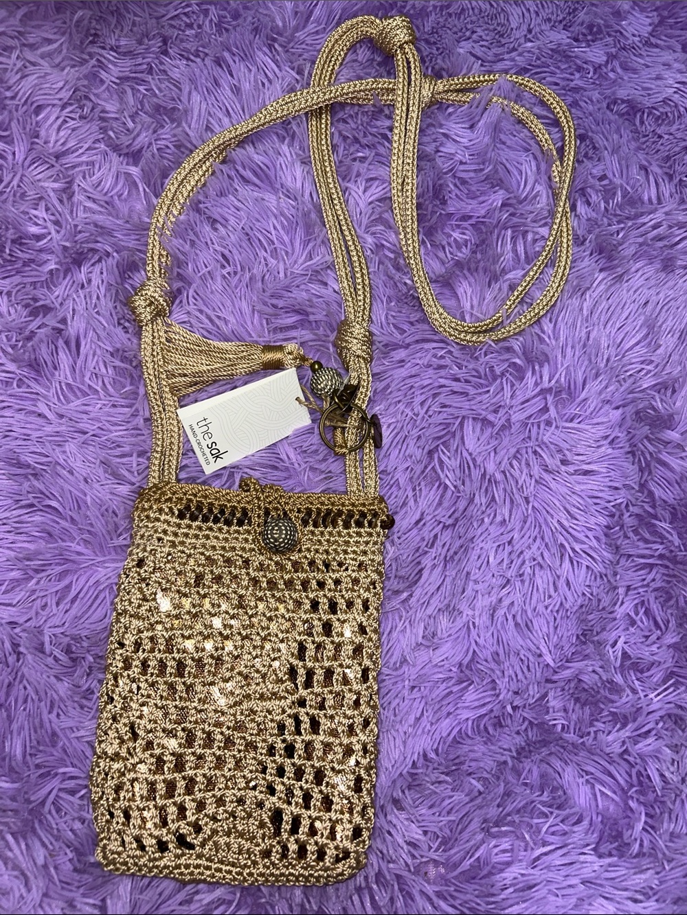the sak Gold Crochet Crossbody Pouch with Tassel